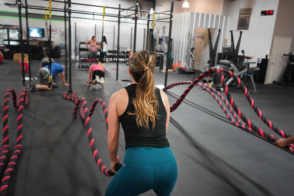 Woman using ropes in a gym to move